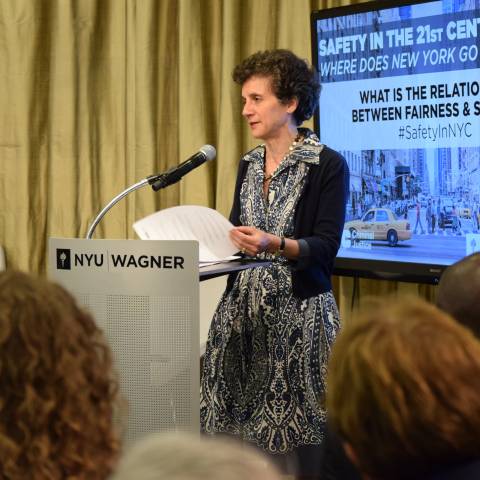 Dean Sherry Glied speaking at the podium in order to start off the panel discussion 