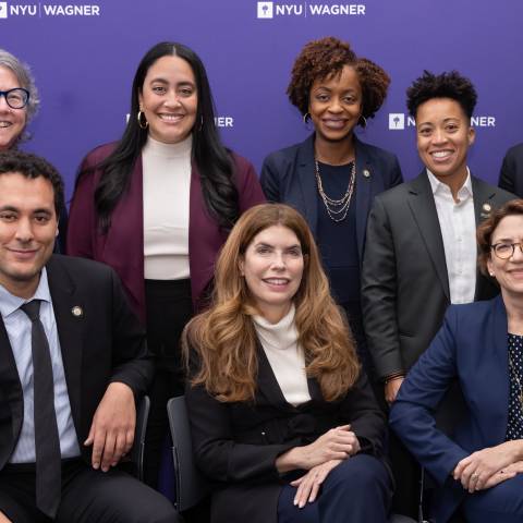 panel posed in front of step-and-repeat