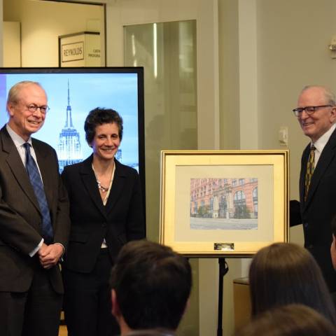Dean Sherry Glied with two other guests posing next to photo frame