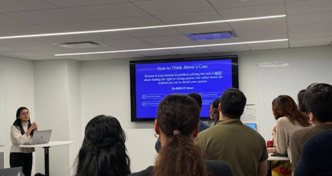 students watching presenter at front of room